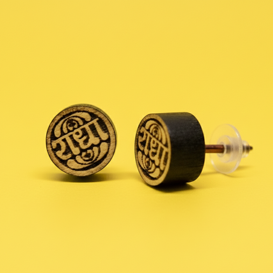 Tulsi Wooden earrings with engraved  Radha text on a yellow background