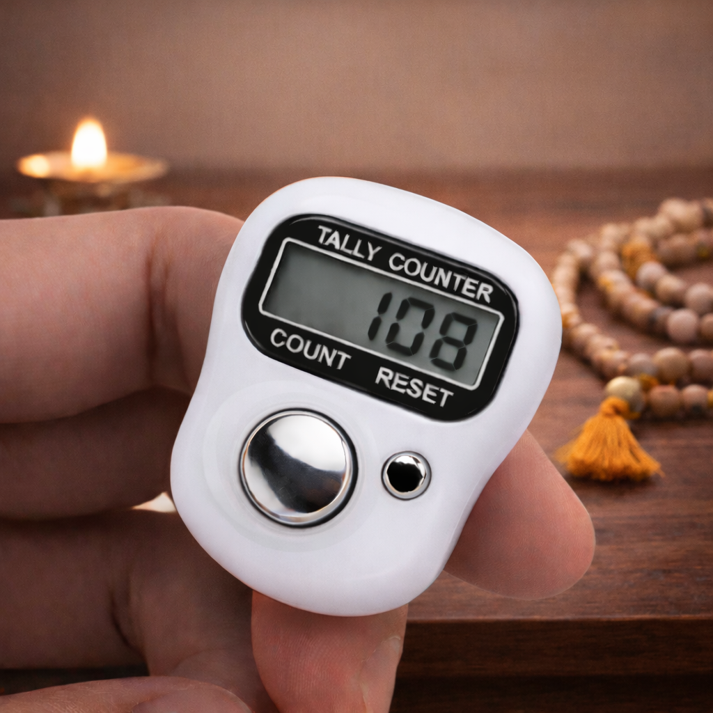 Digital tally counter held in a hand with a blurred background